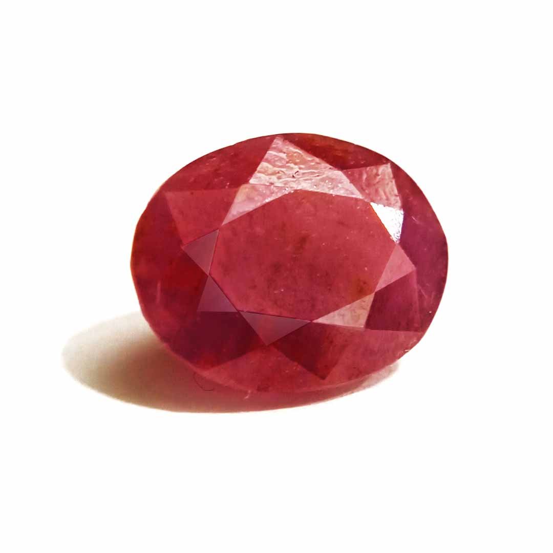 A close-up of a Natural African Ruby gemstone showcasing its rich red hue and brilliant clarity.